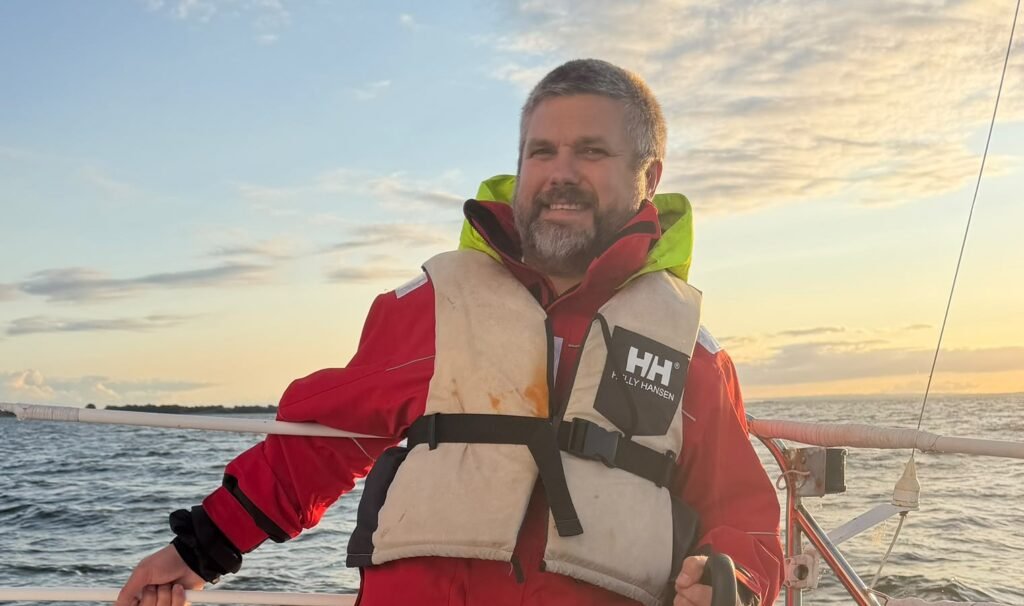 Philip Black, founder of Nauti-Control, at the helm at sunset